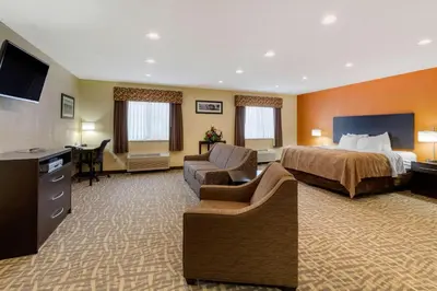 a large hotel room with a bed and a desk at Quality Inn Wooster in Wooster