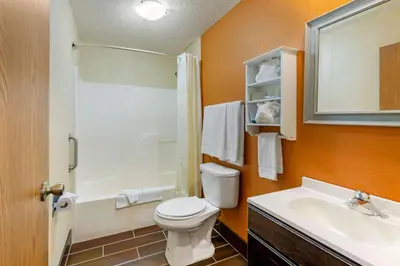 a bathroom with a toilet and a sink and a shower at Quality Inn Wooster in Wooster