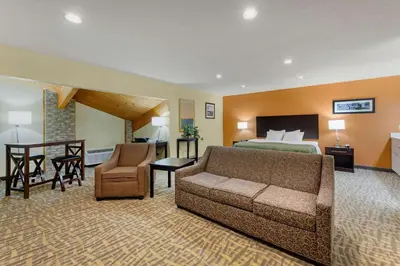 a hotel room with a bed and a couch at Quality Inn Wooster in Wooster