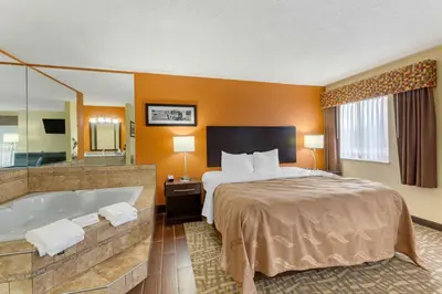a hotel room with a bed and a bath tub at Quality Inn Wooster in Wooster