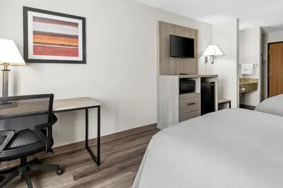 a hotel room with a bed and a desk and a tv at Quality Inn East Liverpool - Calcutta in East Liverpool