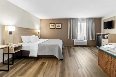 a hotel room with a bed and a television at Quality Inn East Liverpool - Calcutta in East Liverpool