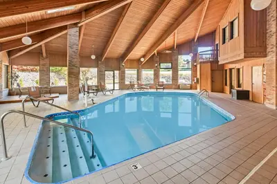 a large swimming pool in a large room with a large ceiling at Quality Inn East Liverpool - Calcutta in East Liverpool