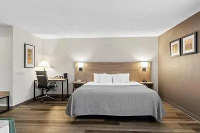 a hotel room with a bed and a desk at Quality Inn East Liverpool - Calcutta in East Liverpool