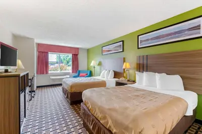 a hotel room with two beds and a flat screen tv at Quality Inn - Huron, Sandusky OH in Huron