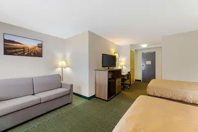 a hotel room with a bed and a couch at Quality Inn - Huron, Sandusky OH in Huron