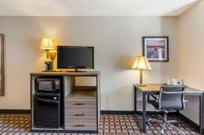 a hotel room with a desk with a tv and a computer at Quality Inn - Huron, Sandusky OH in Huron