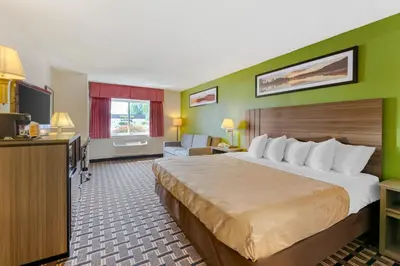 a hotel room with a large bed and a television at Quality Inn - Huron, Sandusky OH in Huron