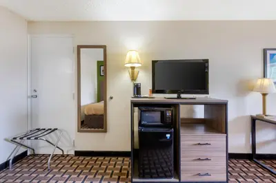 a hotel room with a flat screen tv on a dresser at Quality Inn - Huron, Sandusky OH in Huron