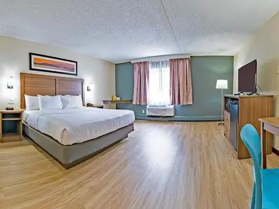 a large hotel room with a bed and a television at Quality Inn Milan-Sandusky in Milan