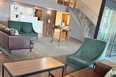 a waiting room with chairs and a staircase at Quality Inn Milan-Sandusky in Milan