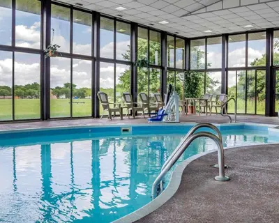 a swimming pool in a building with windows at Comfort Inn Maumee - Perrysburg Area in Maumee