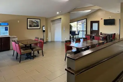 a restaurant with tables and chairs and a bar at Comfort Inn Maumee - Perrysburg Area in Maumee