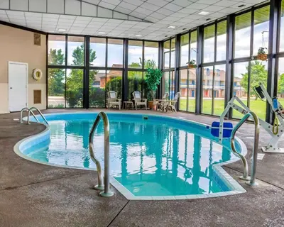 a large swimming pool in a building with windows at Comfort Inn Maumee - Perrysburg Area in Maumee