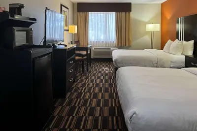 a hotel room with two beds and a flat screen tv at Comfort Inn Maumee - Perrysburg Area in Maumee