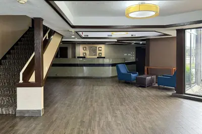 an office lobby with a staircase and blue chairs at Comfort Inn Maumee - Perrysburg Area in Maumee