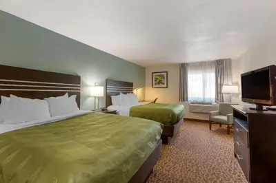 a hotel room with two beds and a flat screen tv at Quality Inn Alexis Rd in Toledo