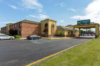 a car dealership with a car parked in a parking lot at Quality Inn Alexis Rd in Toledo