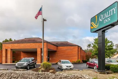 a building with cars parked in a parking lot at Quality Inn Jackson in Jackson