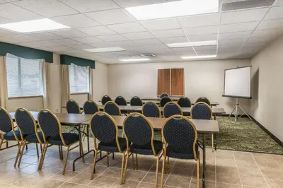 a conference room with tables and chairs and a whiteboard at Quality Inn Jackson in Jackson