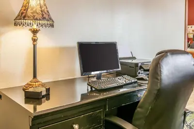 an office with a desk with a computer and a lamp at Quality Inn Jackson in Jackson