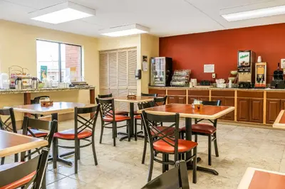 a restaurant with tables and chairs and a counter at Quality Inn Jackson in Jackson