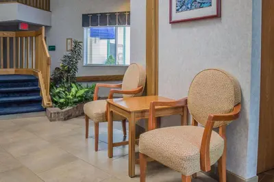a dining room with chairs and a table and a fireplace at Quality Inn Port Clinton Waterfront in Port Clinton