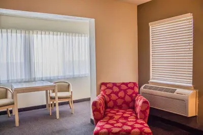 a room with a chair and a table and a window at Quality Inn Port Clinton Waterfront in Port Clinton