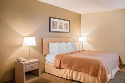 a hotel room with a bed with two lamps and a phone at Quality Inn Port Clinton Waterfront in Port Clinton