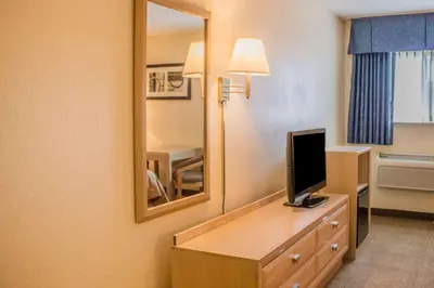 a hotel room with a television and a mirror at Quality Inn Port Clinton Waterfront in Port Clinton