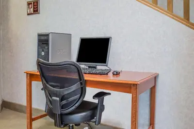 a desk with a computer and a chair at Quality Inn Port Clinton Waterfront in Port Clinton