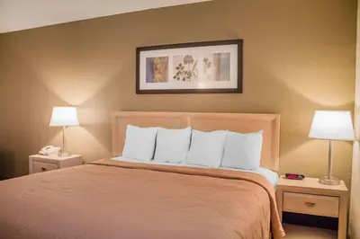 a hotel room with a bed with two lamps at Quality Inn Port Clinton Waterfront in Port Clinton