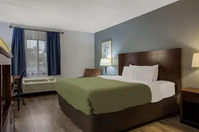 a hotel room with a large bed and a window at Quality Inn Toledo Westgate in Toledo