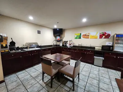 a kitchen with a table and chairs in a room at Quality Inn Wheelersburg in Wheelersburg
