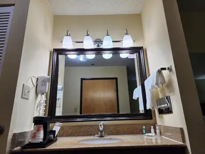 a bathroom with a sink and a large mirror at Quality Inn Wheelersburg in Wheelersburg