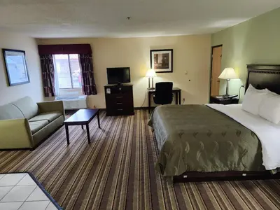 a hotel room with a bed and a couch at Quality Inn Wheelersburg in Wheelersburg