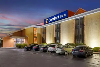 a car dealership with cars parked in a parking lot at Comfort Inn Cincinnati Northeast in Mason