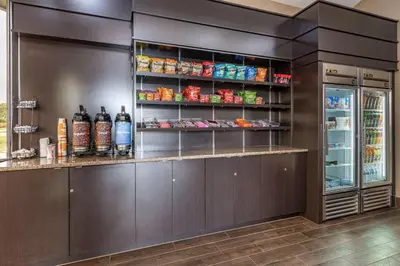 a kitchen with a counter with a refrigerator at Comfort Inn Cincinnati Northeast in Mason