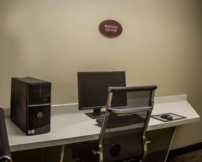 a desk with a computer and a chair on it at Sleep Inn Sandusky in Sandusky