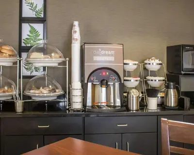 a kitchen counter with a coffee maker and some food at Sleep Inn Sandusky in Sandusky