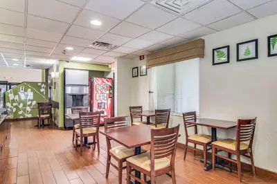 a dining room with wooden tables and chairs at Sleep Inn Austintown - Youngstown, West in Austintown