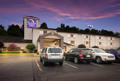 two cars parked in a parking lot in front of a hotel at Sleep Inn Austintown - Youngstown, West in Austintown