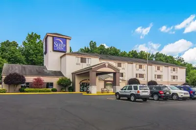 a hotel with cars parked in a parking lot at Sleep Inn Austintown - Youngstown, West in Austintown