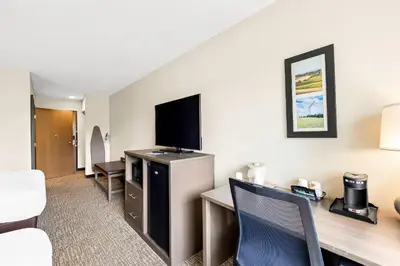 a hotel room with a desk and a tv at Comfort Inn Van Wert in Van Wert