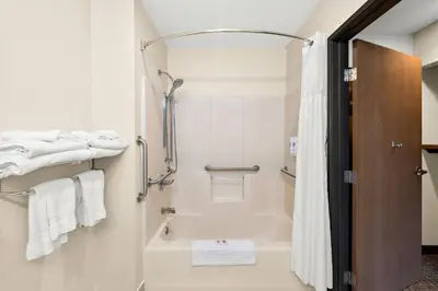 a bathroom with a tub and a shower with white towels at Comfort Inn Van Wert in Van Wert