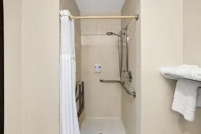 a bathroom with a shower with a shower curtain at Comfort Inn Van Wert in Van Wert
