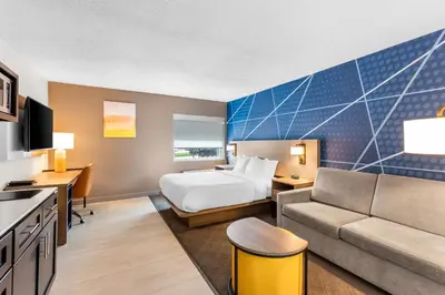 a hotel room with a bed and a couch at Comfort Inn Mayfield Heights Cleveland East in Mayfield