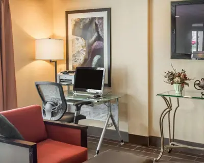 a room with a desk with a computer and a chair at Quality Inn Springboro West in Springboro