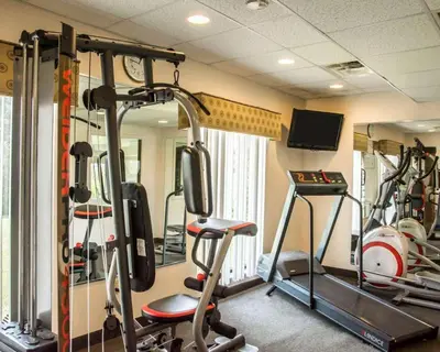 a gym with several tread machines and a tv at Quality Inn Springboro West in Springboro