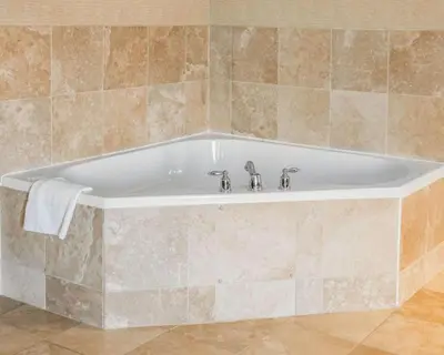 a bath tub with two faucets in a bathroom at Quality Inn Springboro West in Springboro